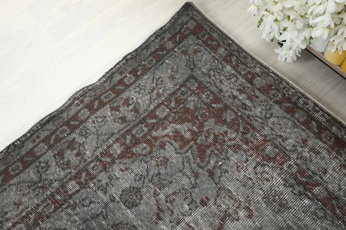 Corner detail of the rug, showcasing the rust-colored border with traditional Anatolian motifs.