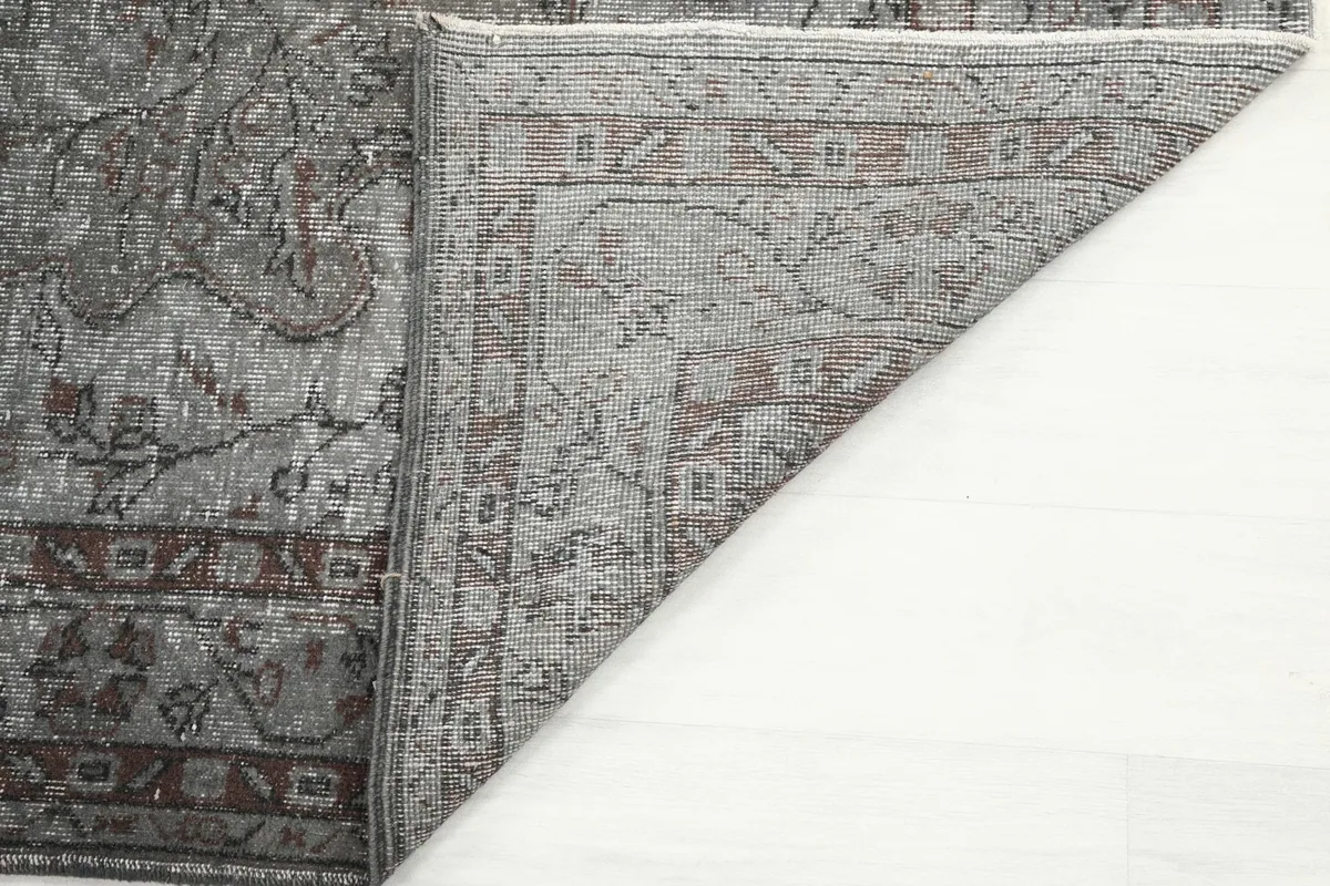 Close-up of the rug's back, revealing the tight hand-knotting and cotton foundation structure.