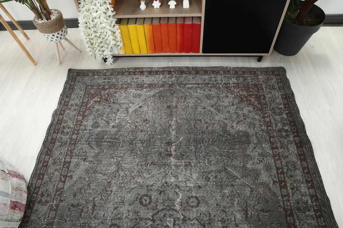 Overhead view of the rug laid out in a room, capturing its full design and proportions.