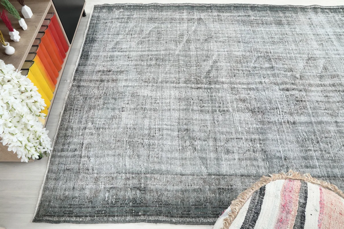 Angled top view of the gray Anatolian rug, emphasizing its rectangular shape and color