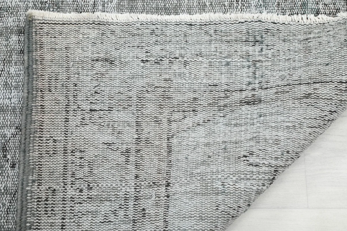 Underside of the rug, showing the knots and cotton foundation structure