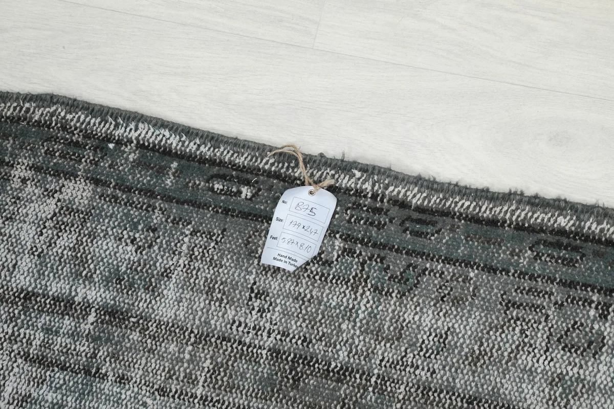 Close-up of the rug's edge with the product tag attached