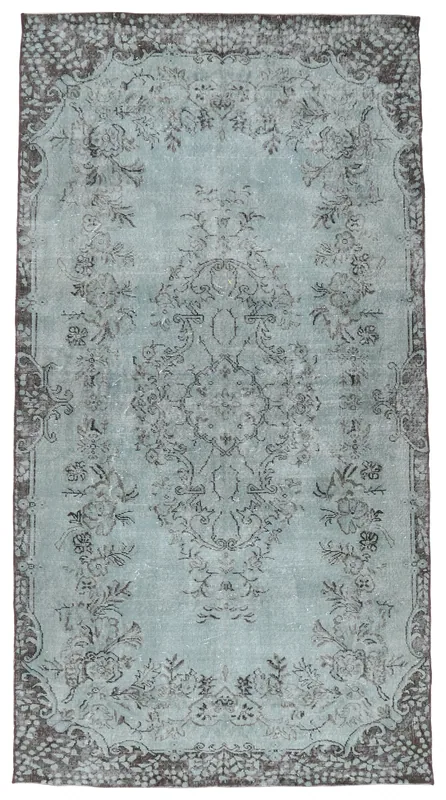 Top view of a blue gray vintage Anatolian area rug with floral medallion design