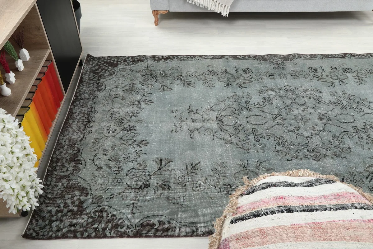 Wide angle of the blue gray rug in a living room, showing its scale relative to furniture