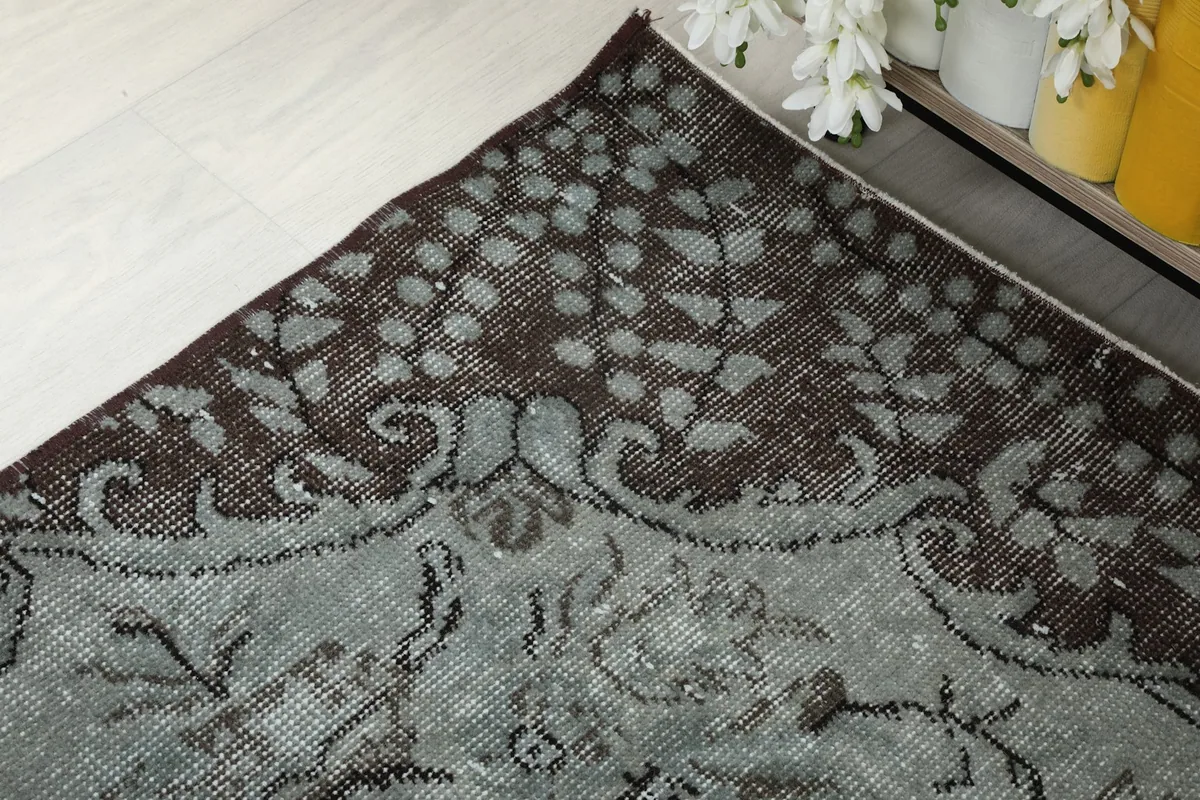 Detailed corner view highlighting the charcoal border and blue gray field