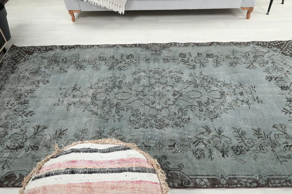 Overhead view of the blue gray vintage rug showcasing its full floral medallion design
