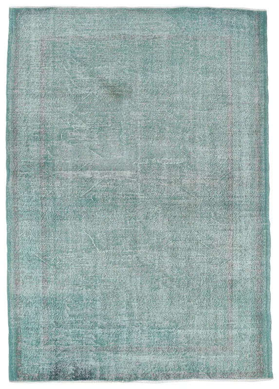 Full overhead view of the green distressed vintage Anatolian area rug on a white background.