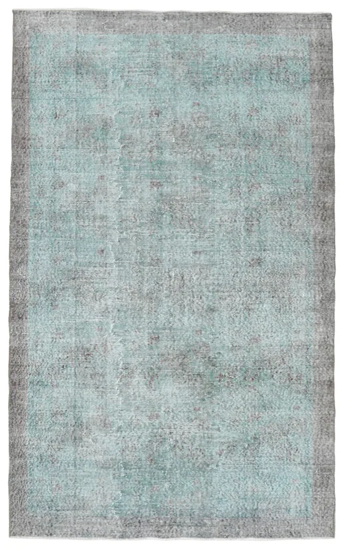 Full overhead view of the blue and gray vintage Anatolian rug on a white background.