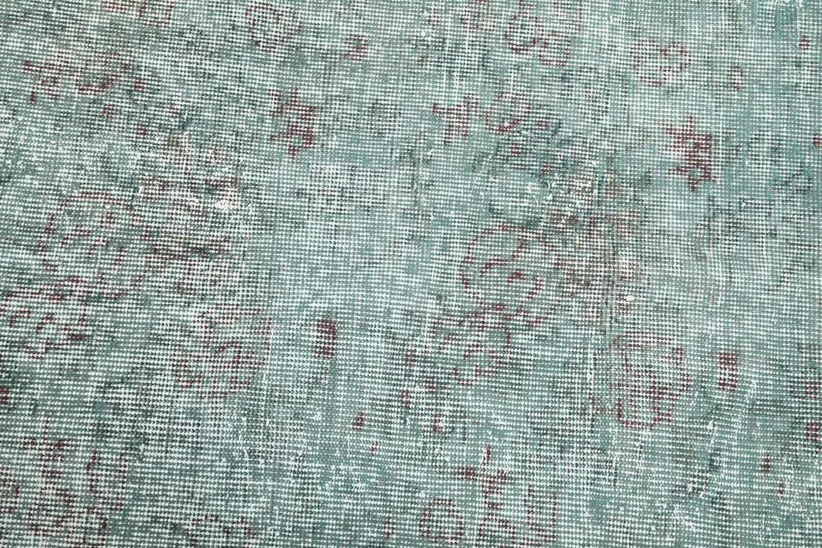 Detailed view of the low wool pile, showing the hand-knotted texture and color variation.