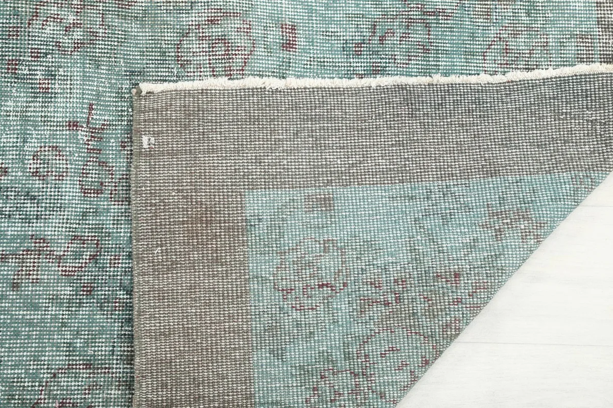 Detailed view of the back of the hand-knotted rug, showing the consistent knotting and foundation.