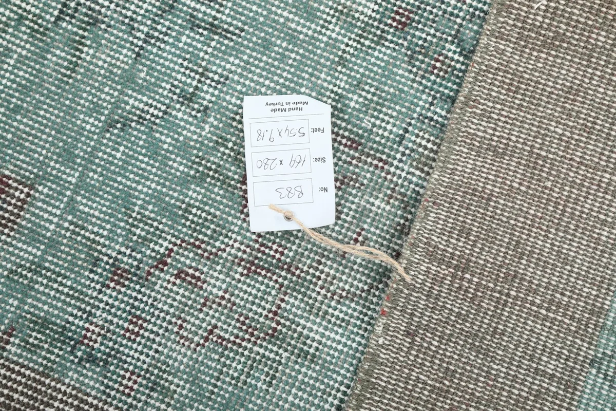 Close-up of the rug's back with a product tag displaying size and origin details.