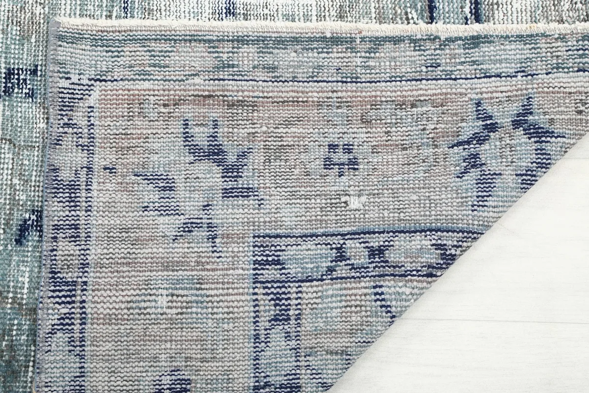 Close-up of the back of the rug, showing hand-knotted construction