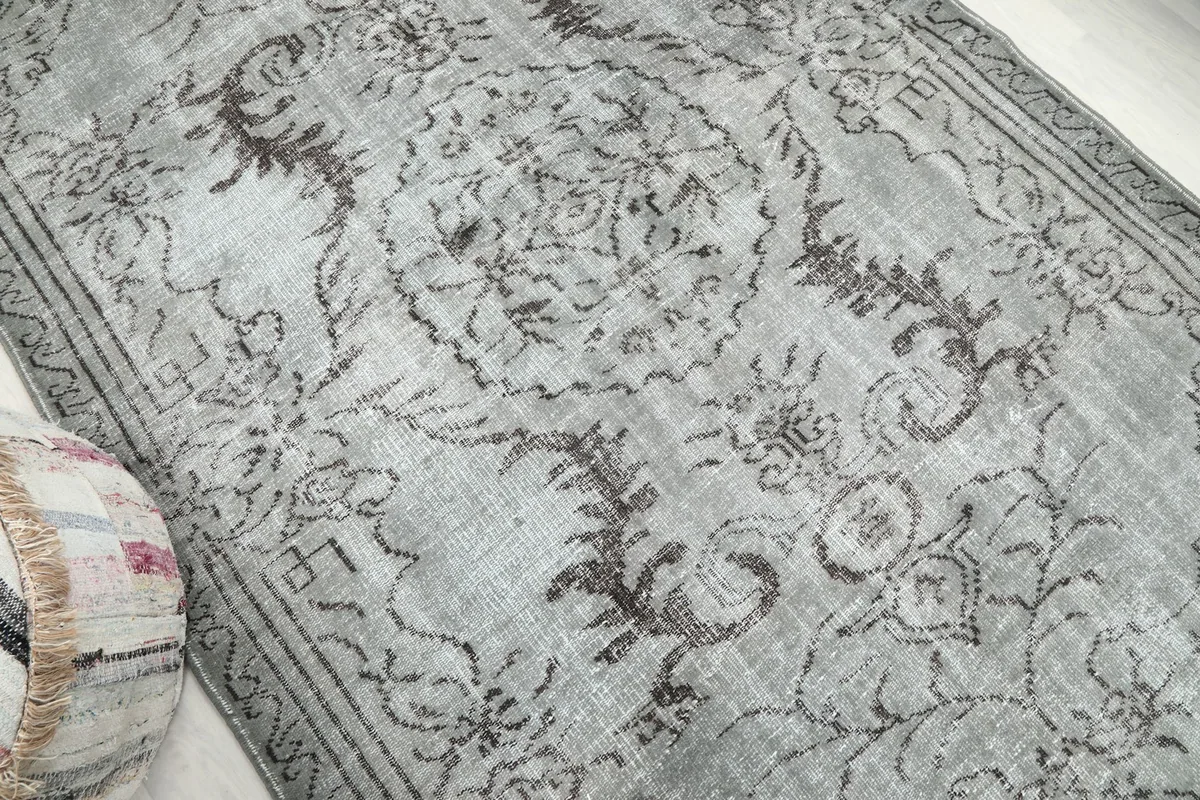 Overhead angle showing the central medallion and surrounding floral motifs on the vintage rug.