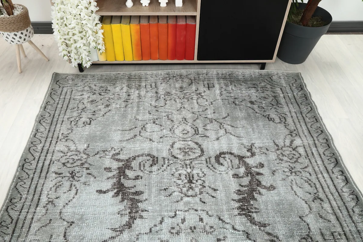 Overhead view of the rug's top half, showing the faded patterns and color variations.