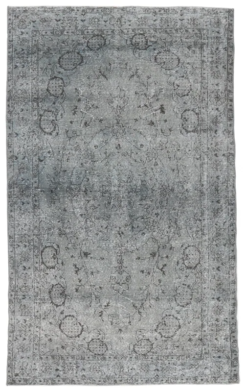 Full overhead view of the charcoal gray vintage Anatolian rug on a white background