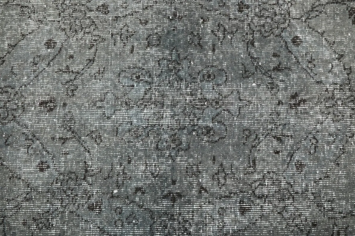 Overhead detail of the central area of the rug, highlighting the faded design and texture