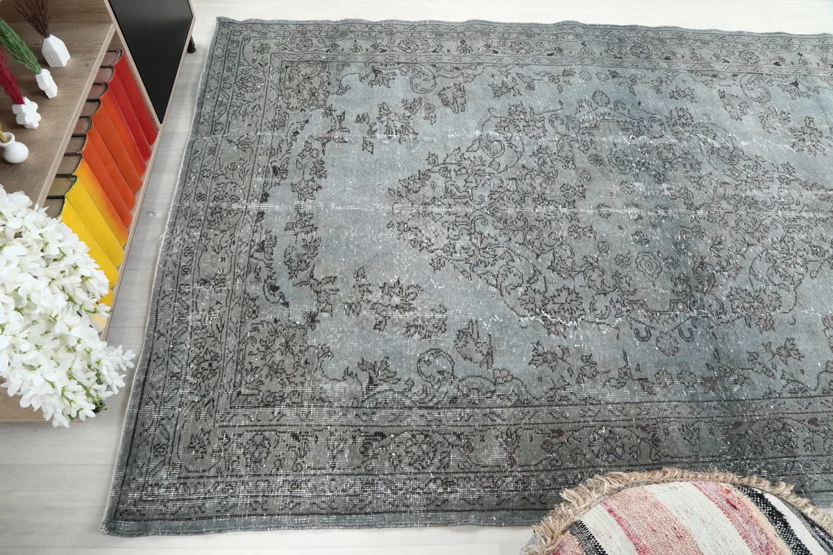 Diagonal view of the blue and gray rug, showcasing its texture and design elements