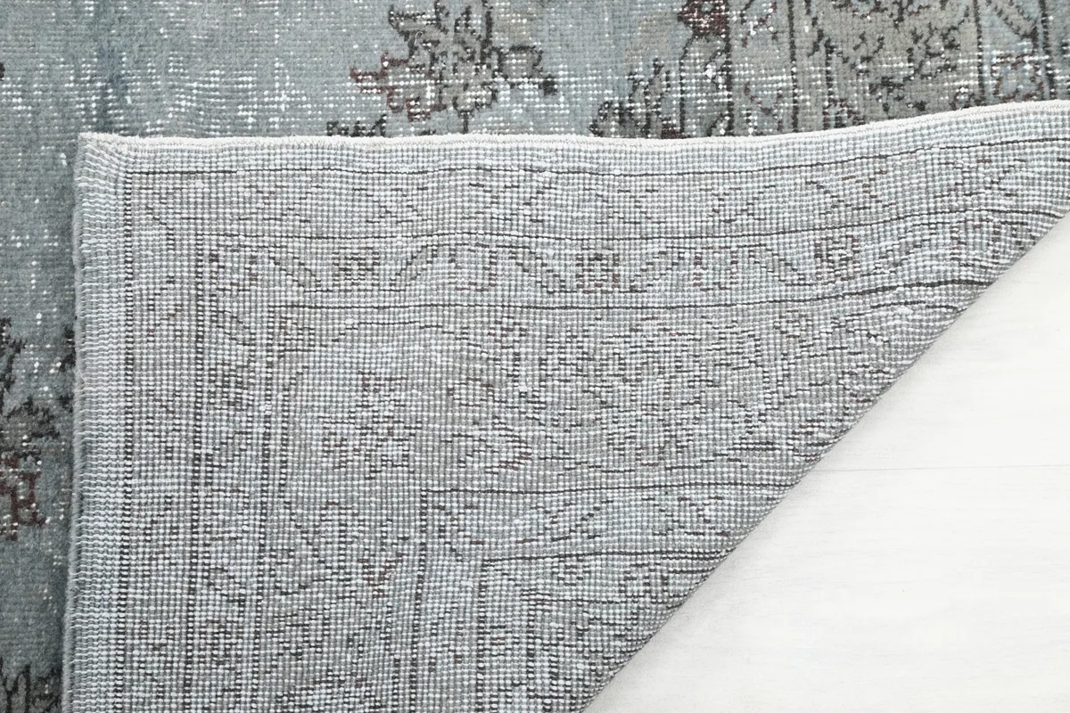 Close-up of the hand-knotted cotton foundation and back of the blue and gray rug