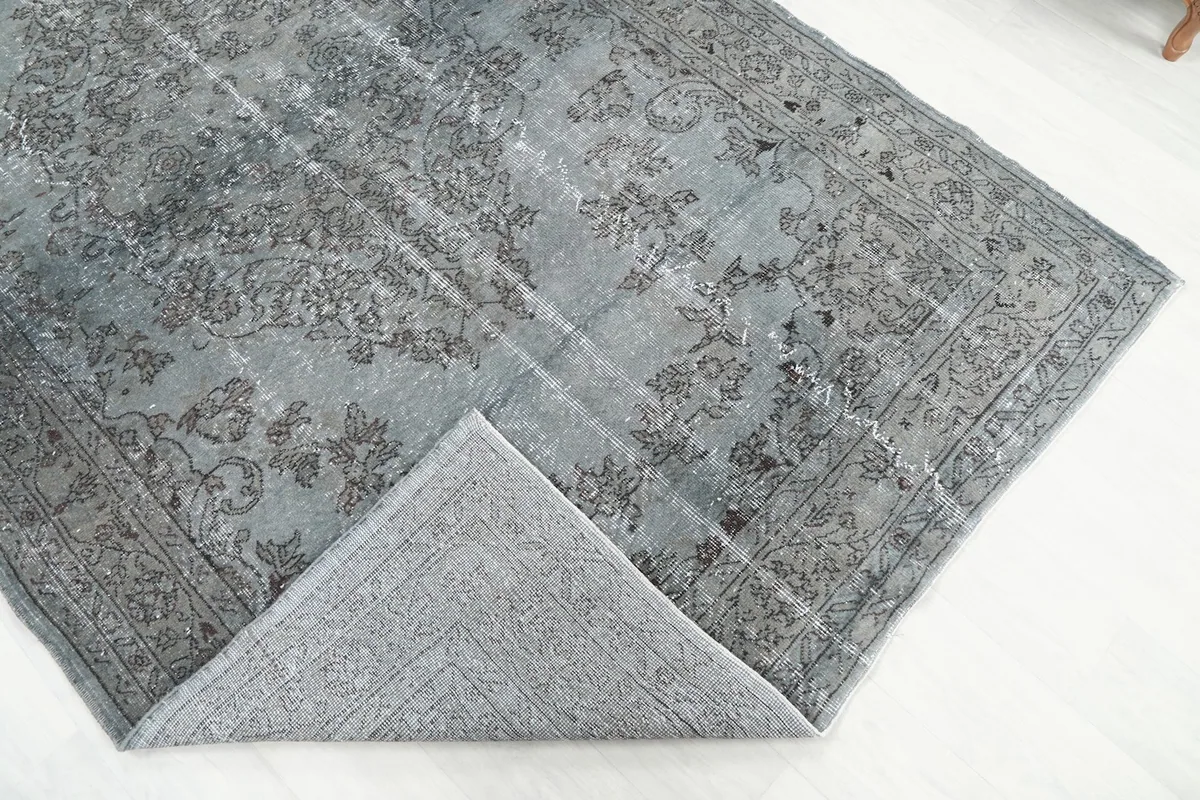 Corner of the hand-knotted rug folded back to reveal the cotton foundation