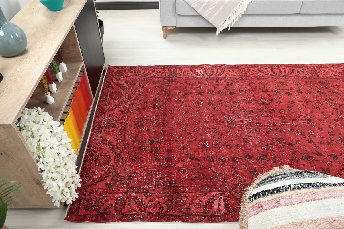 Angled view of the ruby red rug in a room, emphasizing its size and placement