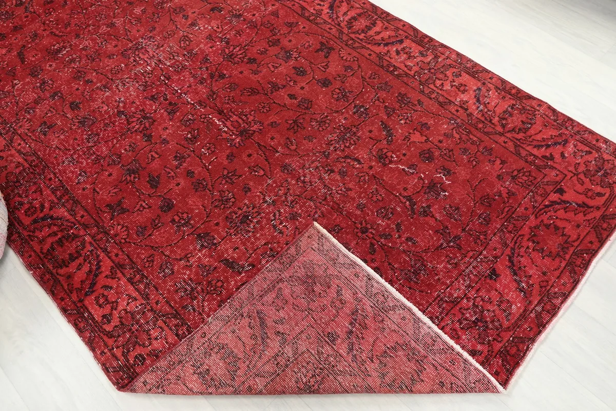 Folded corner of the rug showing the thickness and construction from pile to back