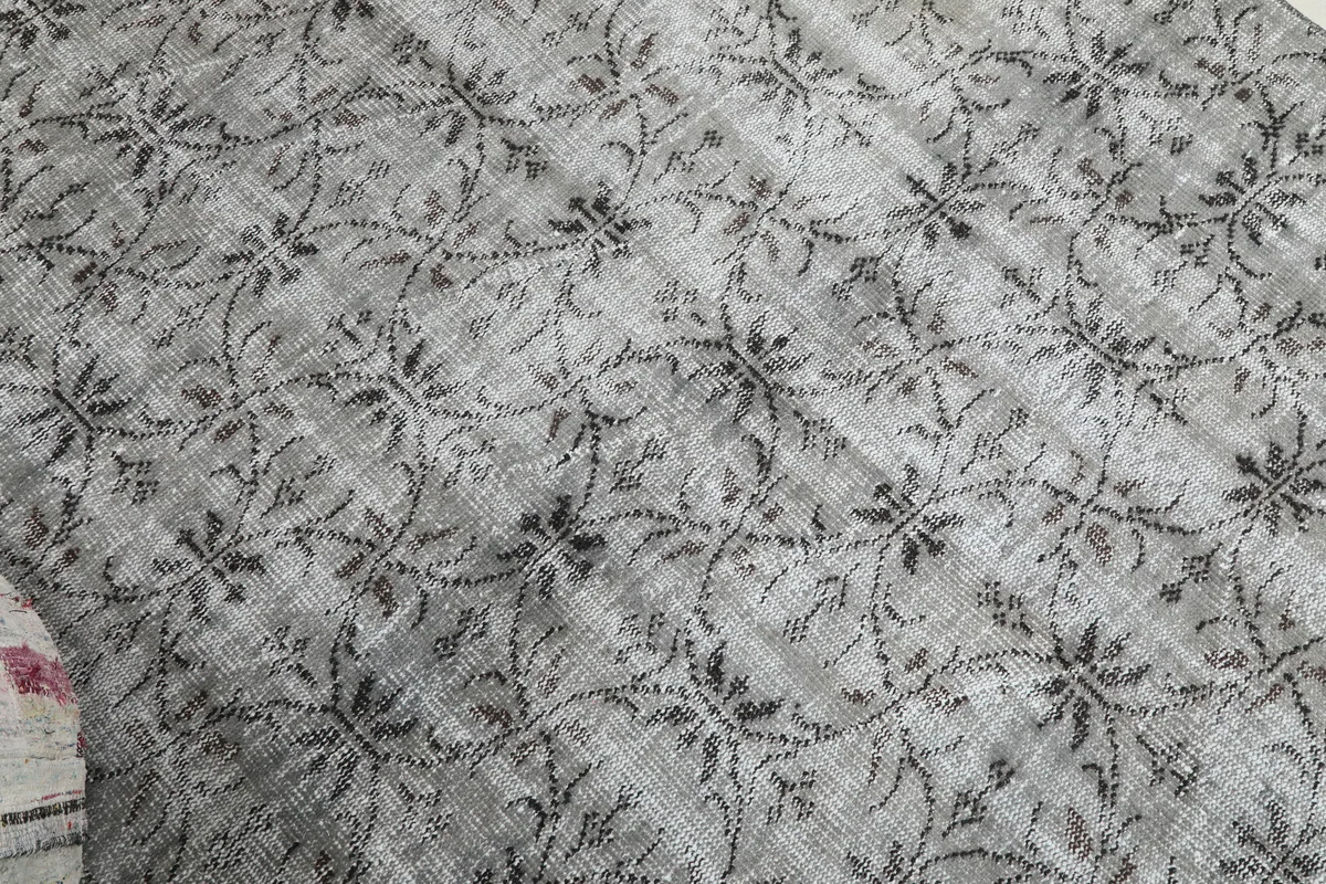 Angled view of the Gray Floral Anatolian Rug, capturing the subtle variations in its gray and charcoal tones.