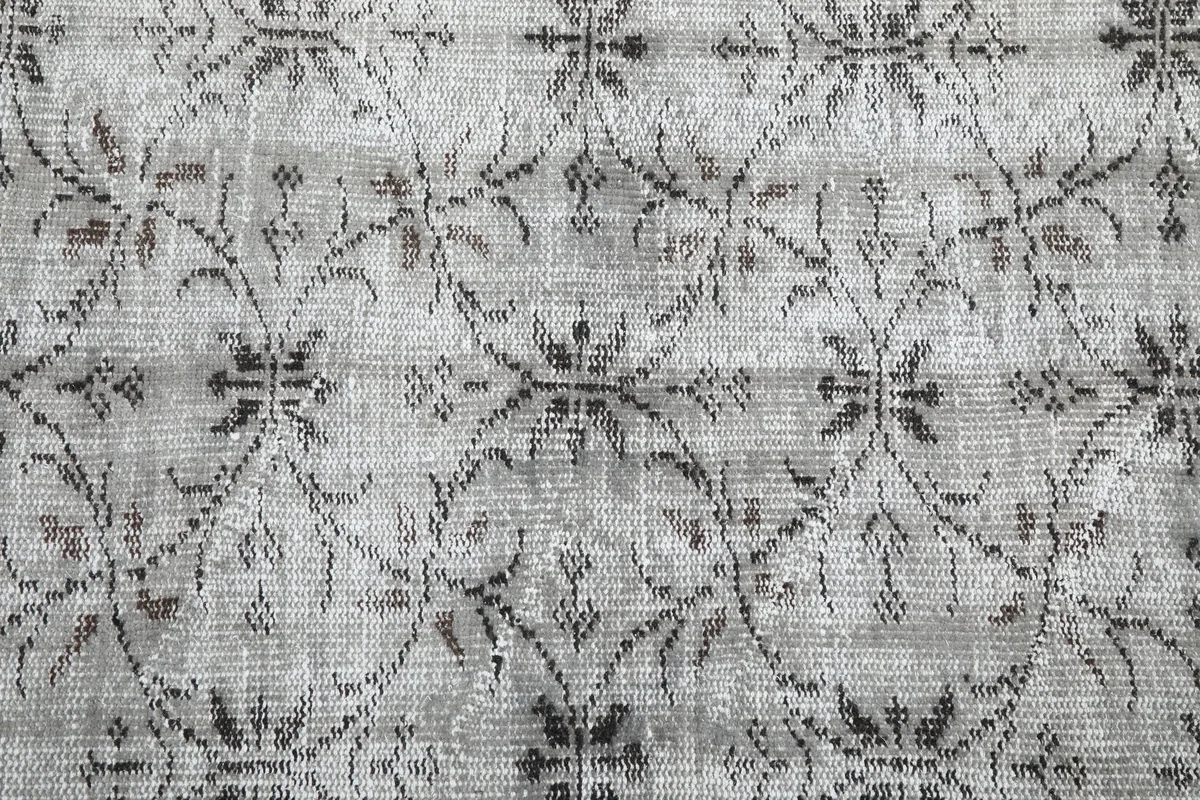 Close detail of the Gray Floral Anatolian Rug's floral-geometric pattern and low pile.