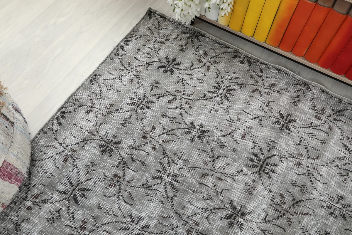 Overhead angle shot of the Gray Floral Anatolian Rug, showing its integration with room decor.