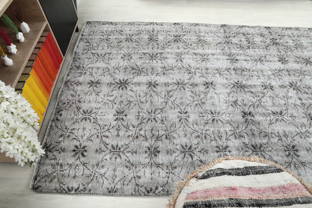 Angled room shot of the Gray Floral Anatolian Rug, displaying its presence in the space.