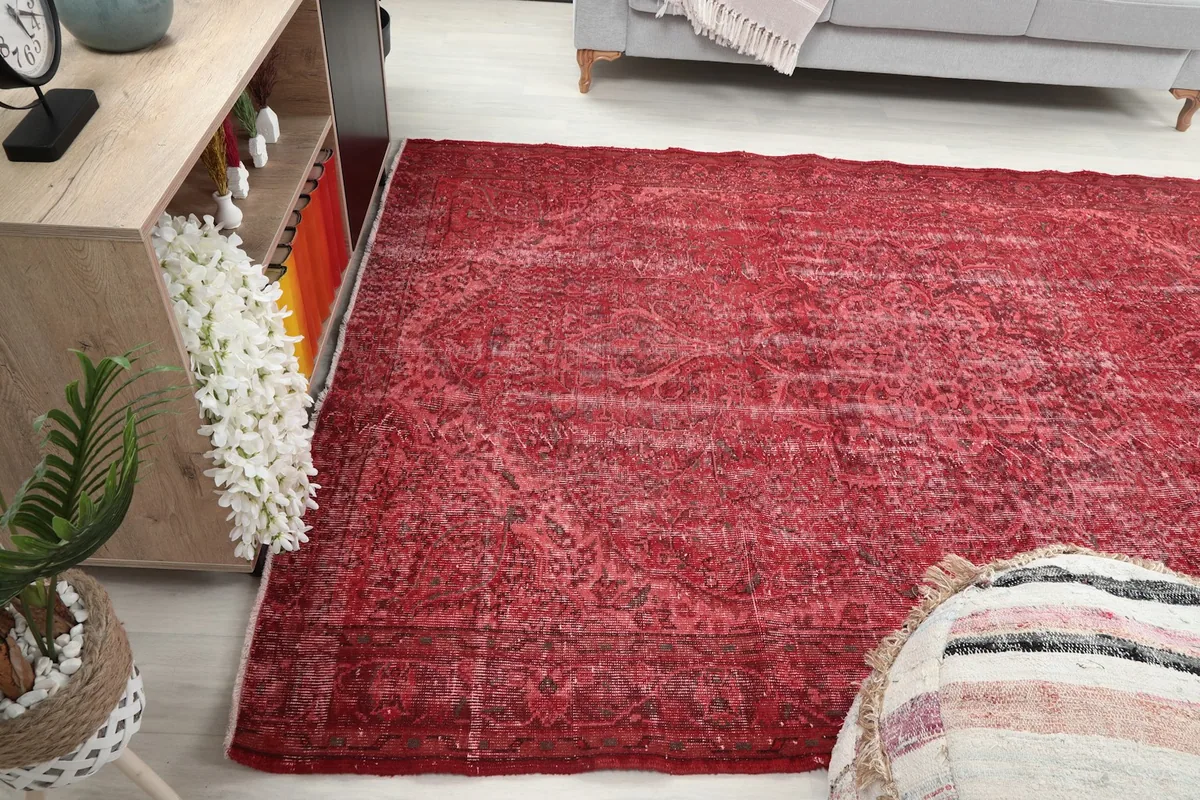 Red vintage rug in a room setting from a different perspective, showing its integration with home decor.