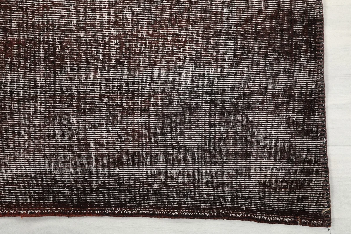 Close-up detail of the rug's edge, highlighting the hand-knotted wool pile