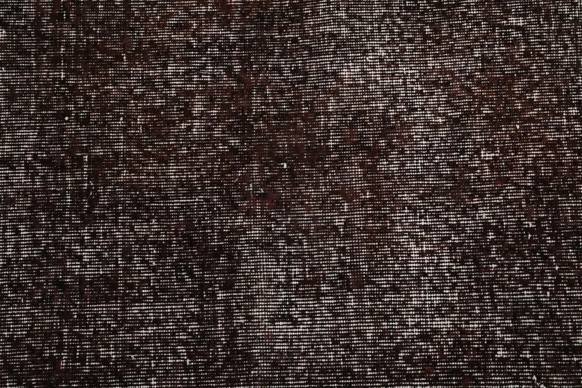 Close view of the low pile, showcasing the distressed finish and wool fibers