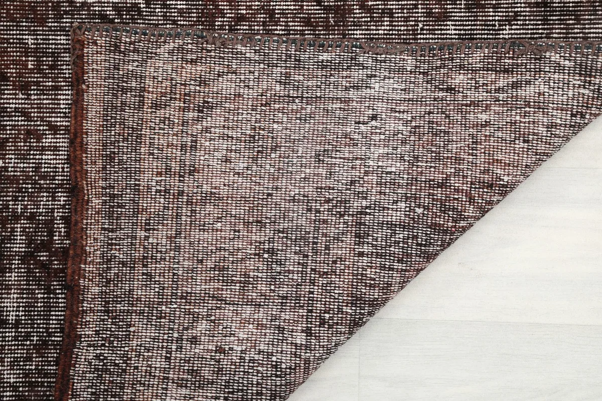 View of the rug's reverse side, showing the hand-knotted cotton foundation