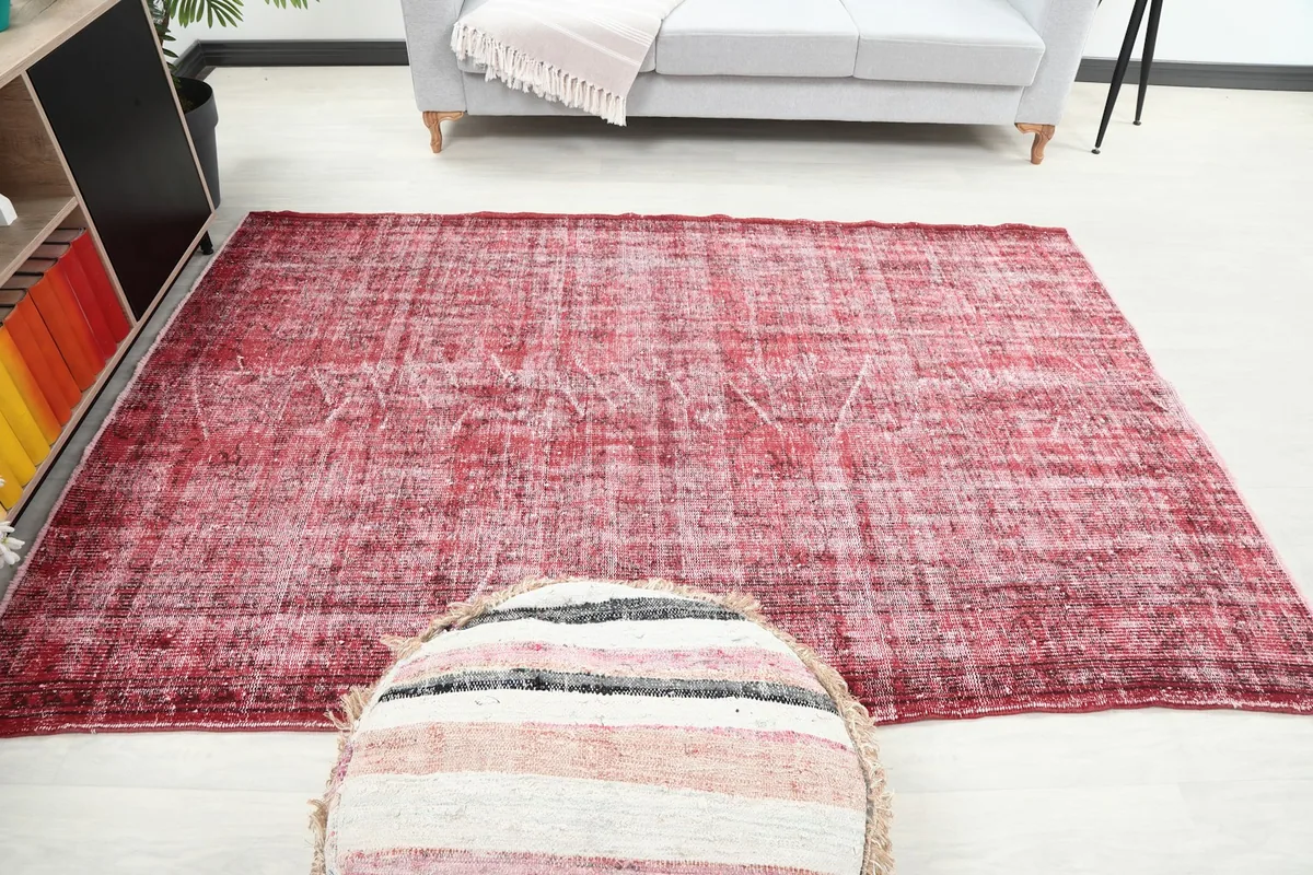 Overhead room view of the red rug, emphasizing its central placement and proportions
