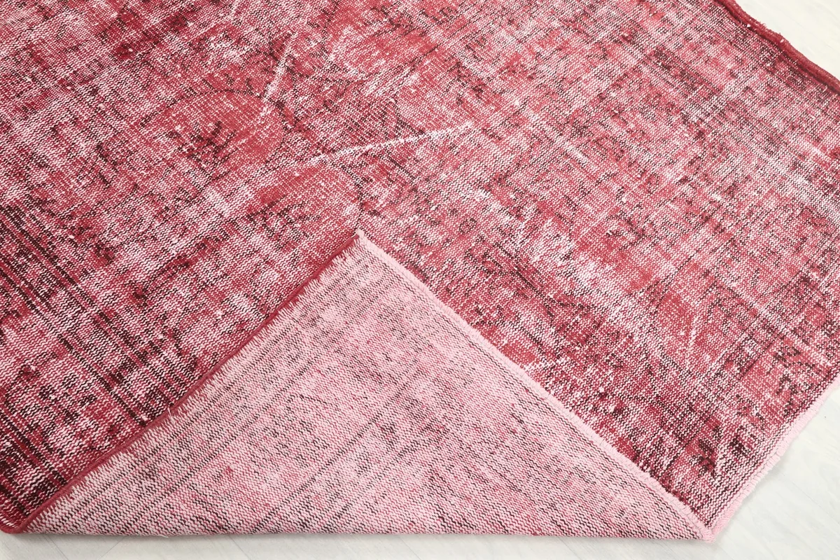 Underside of the rug, showing the cotton foundation and a folded corner