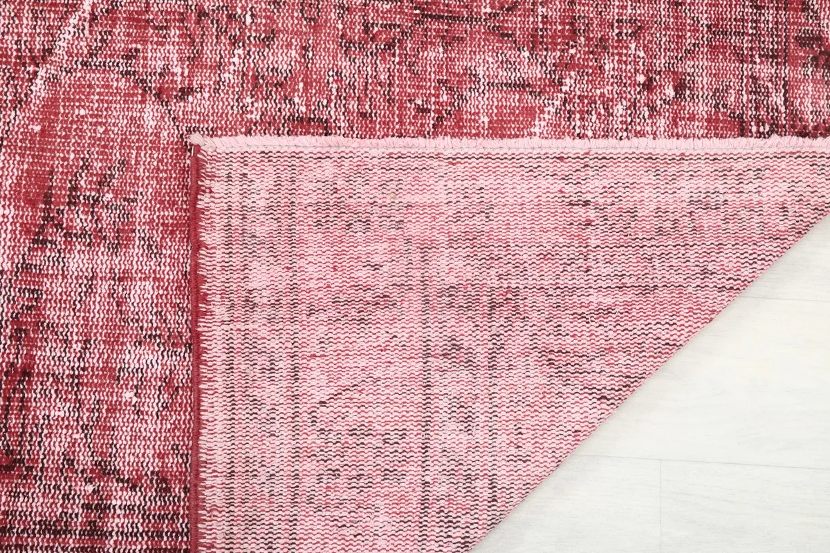 Close-up of the rug's back, revealing the hand-knotted structure and foundation