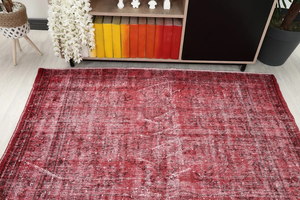 Overhead view of the red vintage rug in a room, showing its placement near furniture