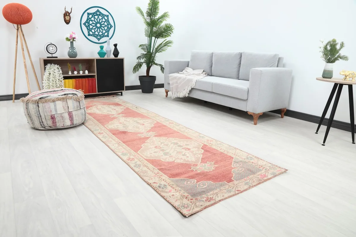 Angled view of the vintage runner rug in a room setting, showing its length