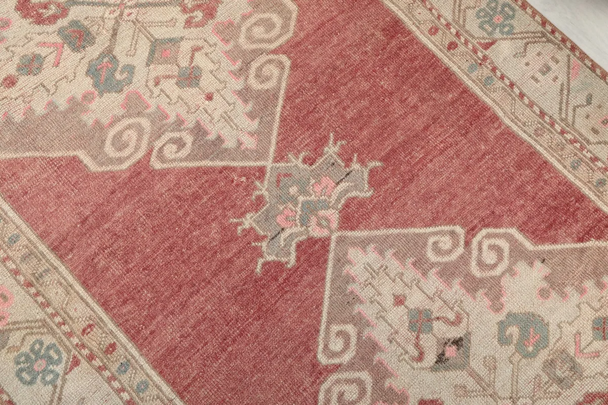 Detailed close-up of a central geometric medallion and surrounding rose field