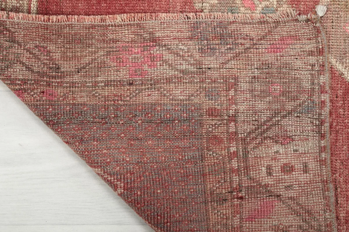Underside of the rug, revealing the hand-knotted cotton foundation and weave