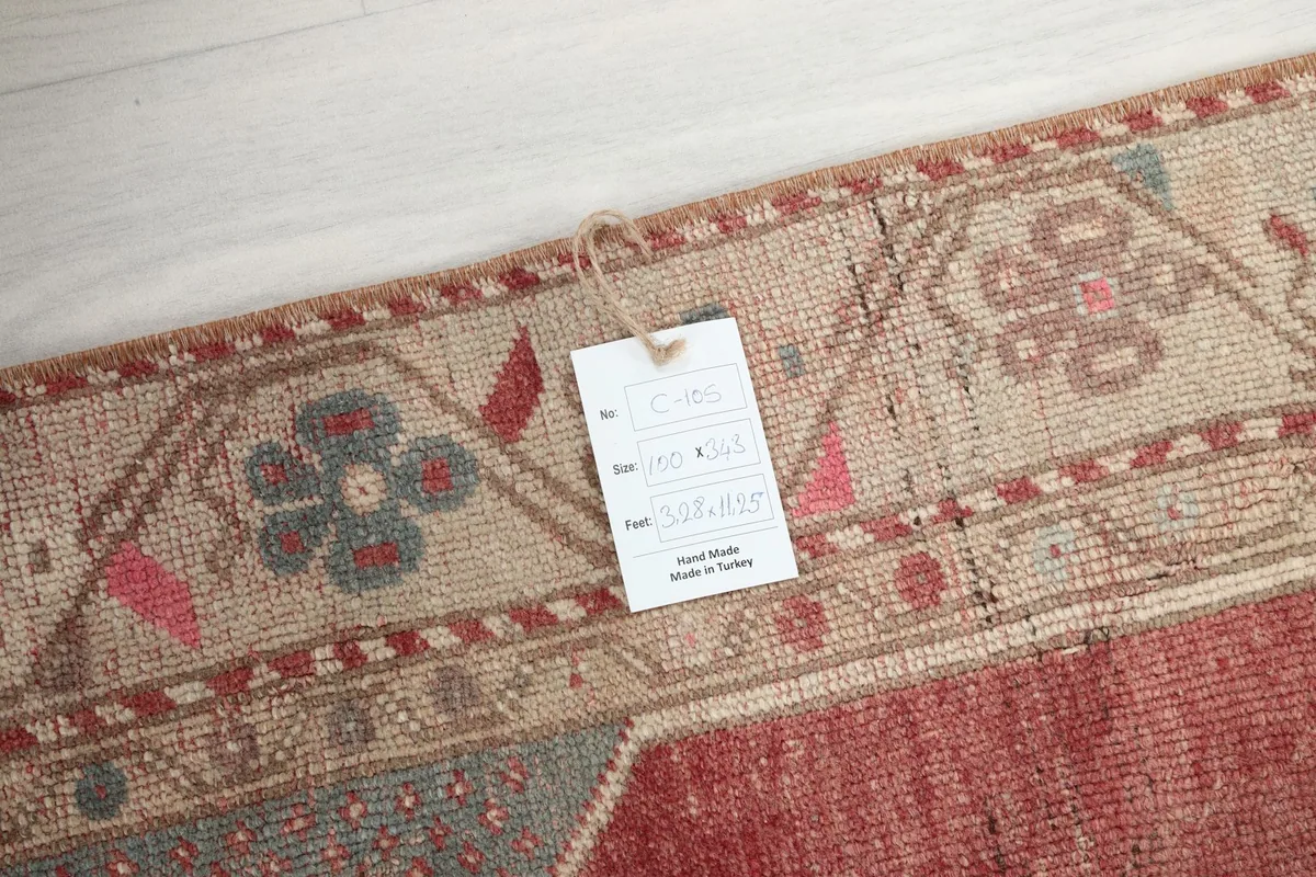 Close-up of the rug's border with a tag, showing details of the hand-knotted texture