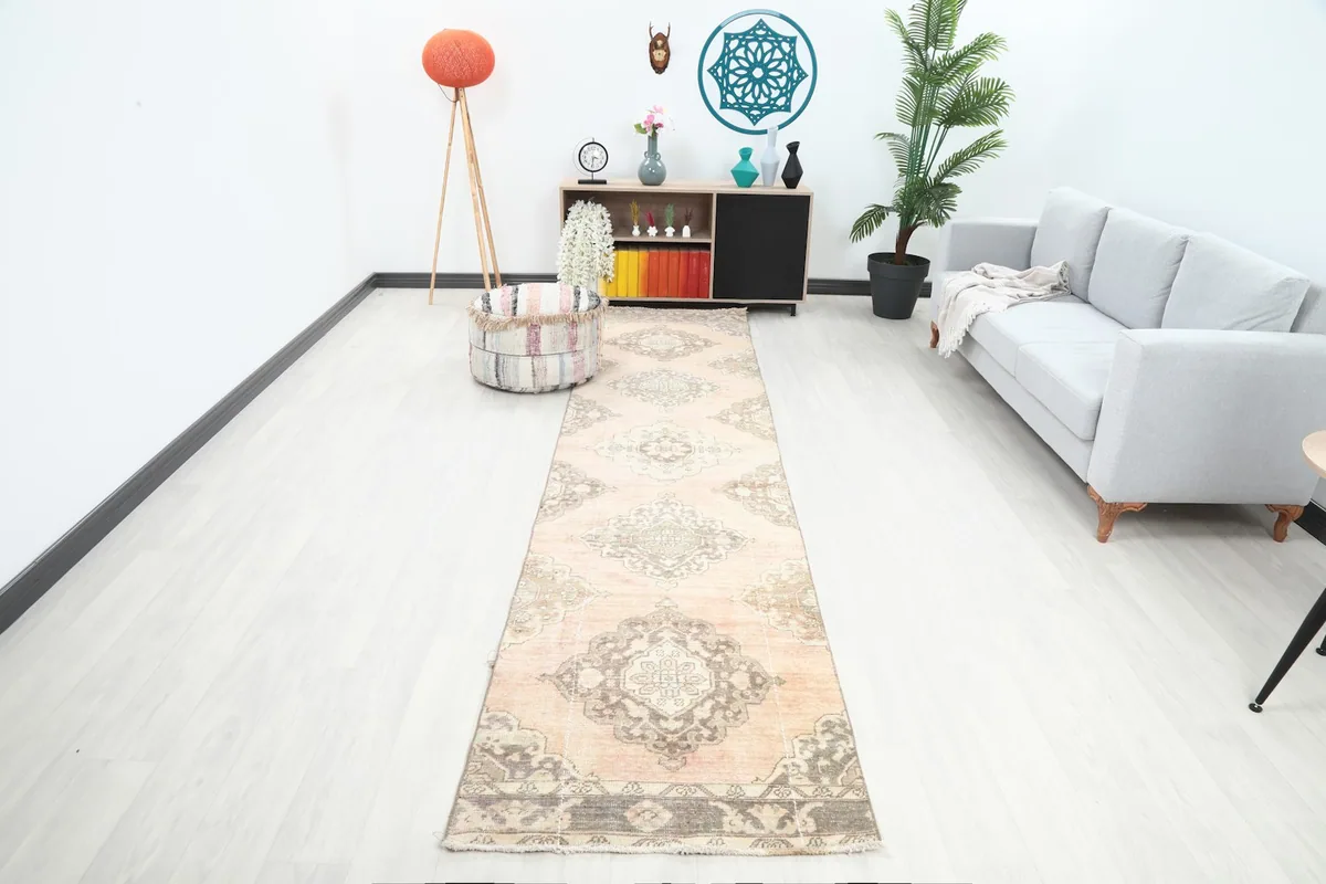 Long view of the vintage runner rug in a modern living space, showing its scale and pattern