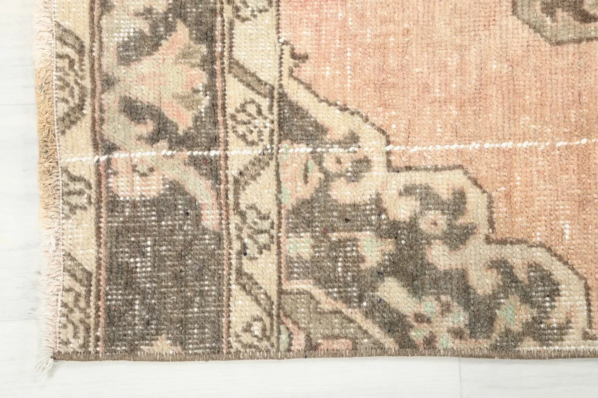 Corner detail of the runner rug, showing the border design and subtle fringe