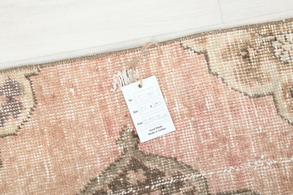 Tag detail showing the rug's specifications, confirming it is hand-knotted and made in Turkey