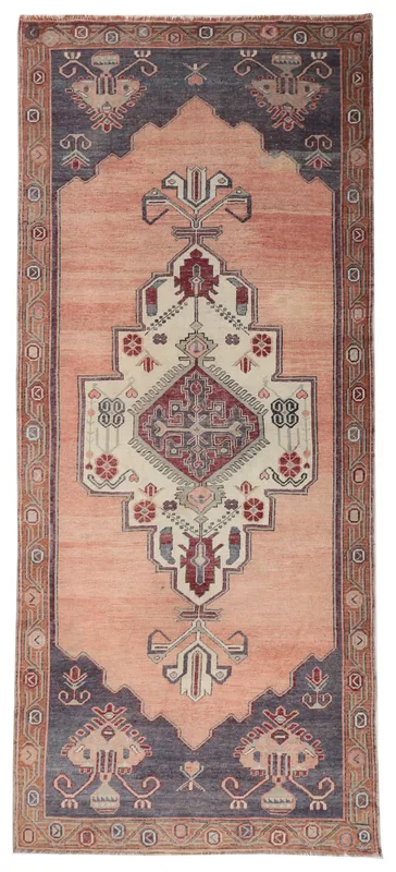 Full top view of the vintage orange and navy tribal runner with a central medallion