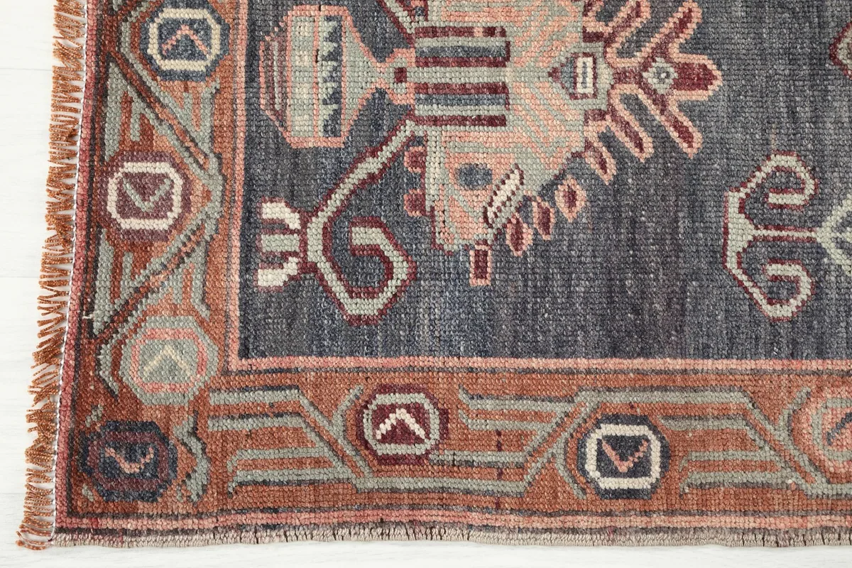 Close-up detail of the navy border and outer rust-colored border with geometric designs