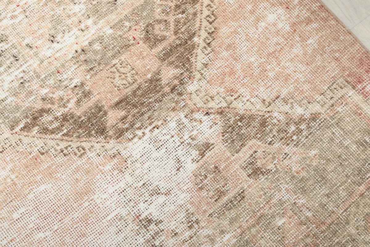 Close-up of the wool pile and intricate hand-knotted details of the vintage rug