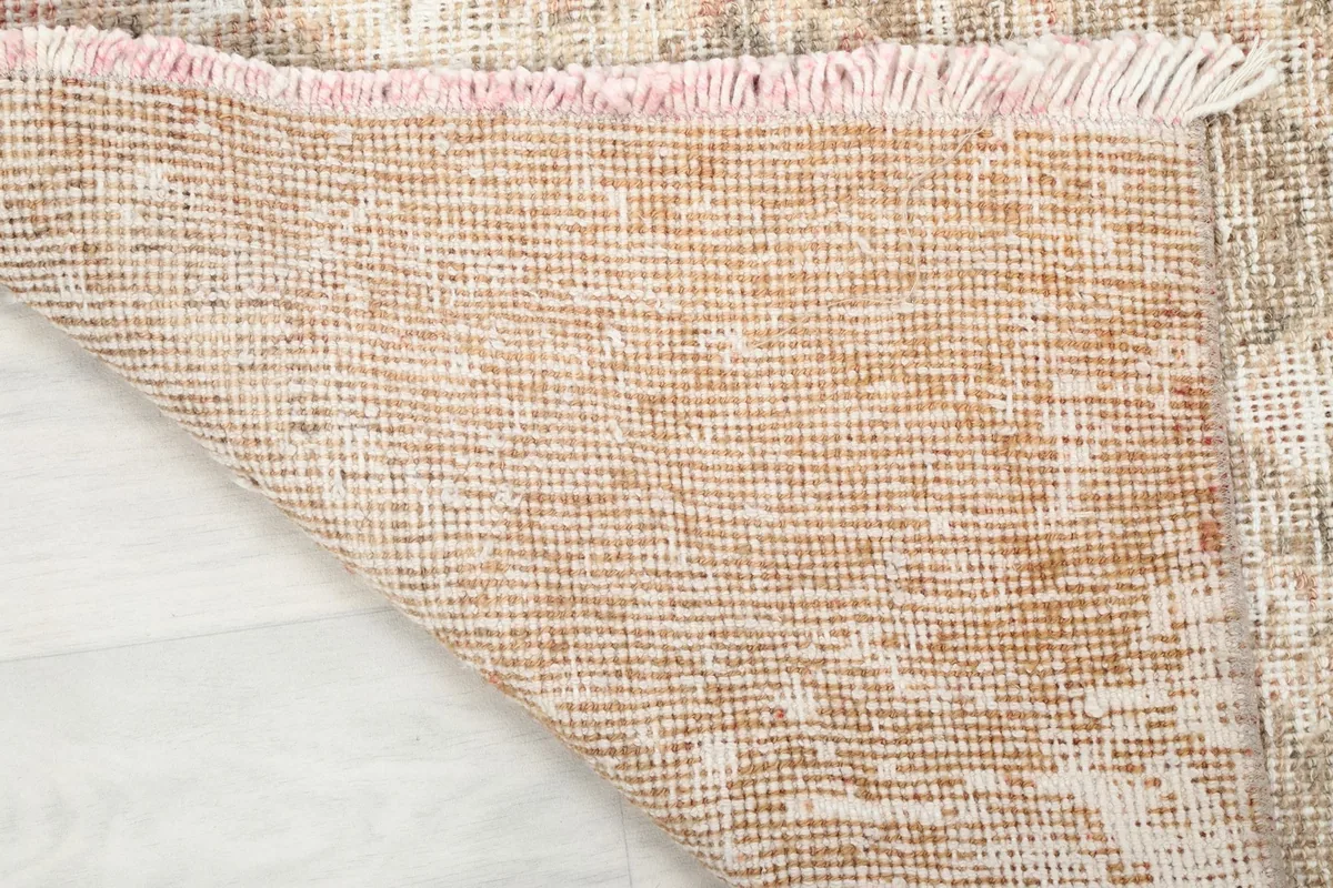 Underside view of the hand-knotted cotton foundation of the vintage Anatolian runner