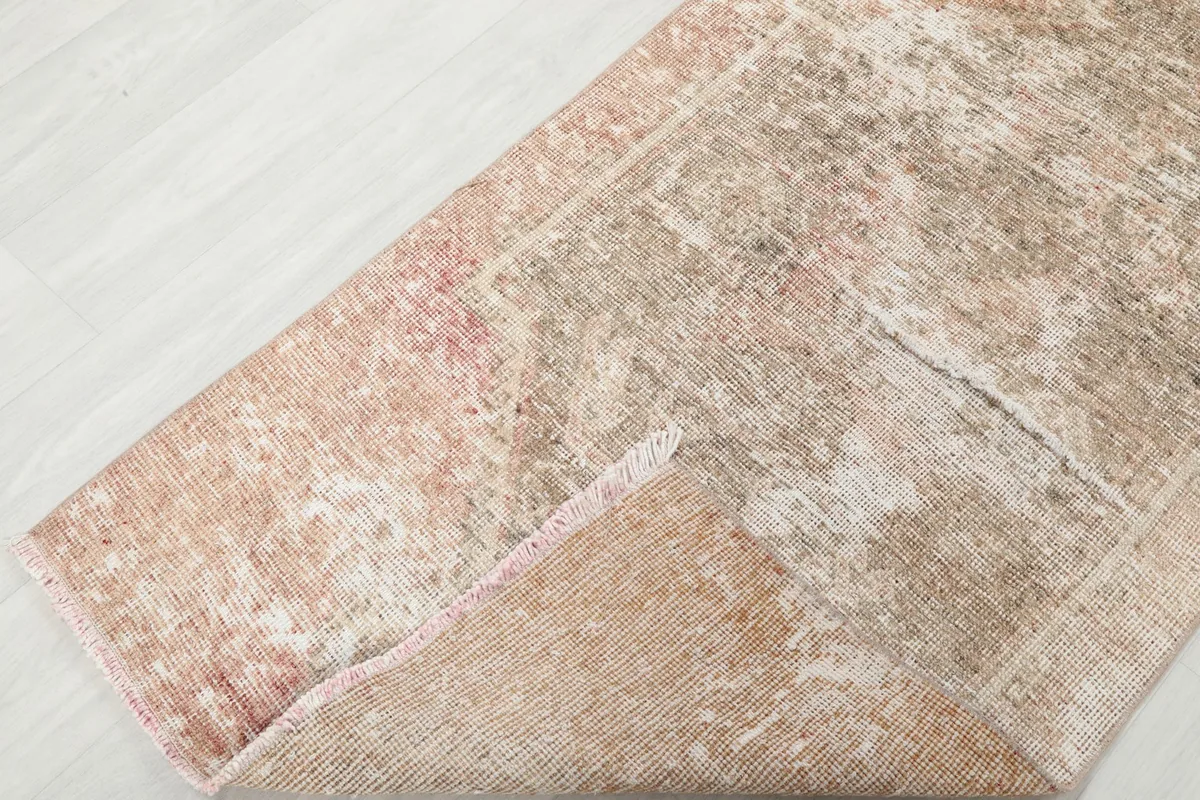 Folded corner of the runner rug showing the flexible wool pile and cotton foundation