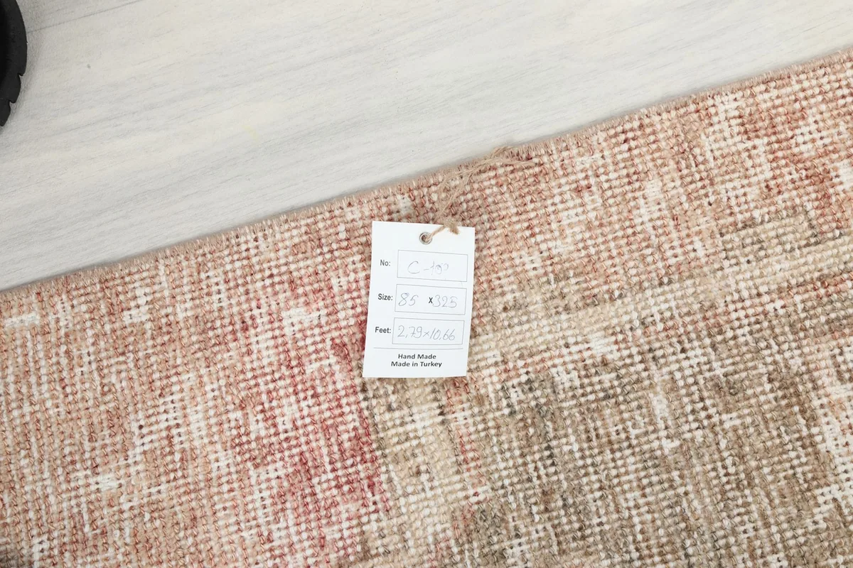 Product tag on the corner of the rug, showing details of its origin and material